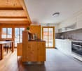 kitchen with dining area, wooden ceiling, wooden floor, large windows, modern appliances, dining table, chairs