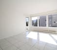empty room, white tiles, white walls, large windows, balcony