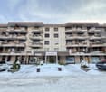 Chasa Belmunt building with multiple balconies, entrance, multiple floors, winter surroundings