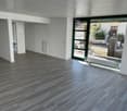 empty room, wooden floor, large glass door, white walls, heater
