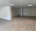 Empty room with wooden flooring, white walls, and white ceiling.