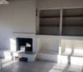 fireplace, white tiles, built-in shelves, electrical outlets