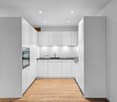 modern kitchen with white cabinets, wooden floor, black countertops, integrated oven, dishwasher, sink, faucet