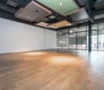 large open space, wooden floor, white walls, glass doors, modern ceiling design