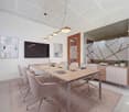 modern office room with a large table, chairs, a TV, paintings, a cabinet, and a rug