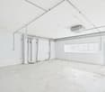 empty room, white walls, ceiling with pipes, windows, open door