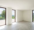 large glass doors, balcony, tile flooring, white walls, balcony railings, views of green landscape
