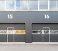 Two garage doors, each with three windows, labeled 15 and 16