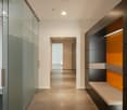modern hallway, glass wall, tiled floor, white walls, ceiling lights, empty room