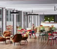Large open-plan office space with modern, colorful furniture and decor. Includes comfortable seating areas, dining tables, and a green wall feature. Large windows provide natural light and views of the exterior. Overall, a vibrant and collaborative work e