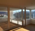 Glass sliding doors, wooden floor, large windows, balcony, modern design, views of the mountains and town