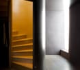 spiral staircase, yellow wall, gray floor, white ceiling, light