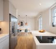modern kitchen with marble countertops, stainless steel refrigerator, induction cooktop, wooden floor, dining table with chairs, pendant lights, artwork on the wall, window with view