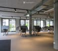 modern office design, carpeted floor, adjustable desks, metal columns, large windows