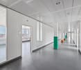 white walls, glass doors, gray floor, windows