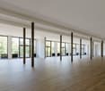 large open space, wooden floor, large windows, pillars, balcony