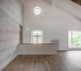 empty room, wooden floor, white walls, concrete wall, windows, radiator