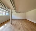 empty room, wooden floor, white walls, windows, pipes on ceiling