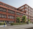 Red brick office building, large windows, multiple floors, tree landscaping, sidewalk, entrance