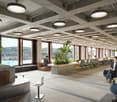 large room with office chairs and desks, plants, concrete ceiling with multiple lights, windows with a city view