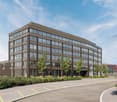 modern office building, multiple floors, large windows, brown exterior, parking area
