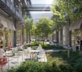 Outdoor seating area with tables and chairs, trees, plants, and a walkway