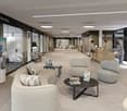 modern waiting area with couches, tables, and a reception desk