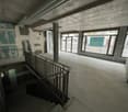 interior building with staircase, white concrete floor, unfinished wall