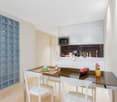 modern, white cabinets, built-in dishwasher, integrated microwave, white dining table, white chairs