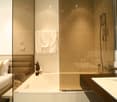 walk-in bathtub, mirror, countertop sink, shower, towels
