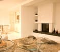 modern living room, glass tables, couches, fireplace, white walls, glass doors