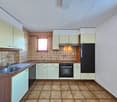 modern kitchen with wooden countertops, stainless steel sink, dishwasher, oven, refrigerator, tiled flooring, tiled walls, cabinet space