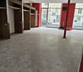 empty room, grey tiles, built-in wardrobes, glass doors, two long shelves, red walls