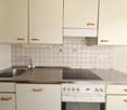 Modern kitchen with sink, oven, dishwasher, and faucet