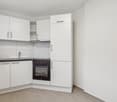 kitchen, modern white cabinets, tile floor, dishwasher, washing machine, electric stove, sink, power outlet