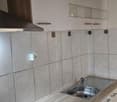 white cabinets, tile backsplash, stainless steel sink, electric stove, range hood
