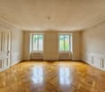 wooden parquet floor, white walls, white ceiling, radiators, large windows with white shutters