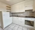 modern kitchen with white cabinets, tiled floor, stainless steel countertop, sink, faucet, gas stove, oven, power outlet, shelves