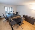 modern office with desk, lamps, chairs, cabinet, window