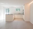 modern kitchen, white cabinets, granite countertop, sink, oven, windows, balcony