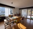 dining room with table, chairs, buffet, large windows, outdoor access