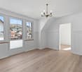 empty room, wooden floor, white walls, chandelier, large windows, balcony