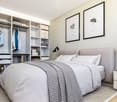 Bedroom with a bed, a nightstand, a wardrobe, and a rug