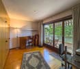 wooden floor, desk, chair, lamp, rug, sliding glass door, balcony, table, chairs, trees