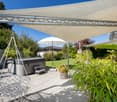 outdoor umbrella, hot tub, white hanging chair, terrace with large canopy