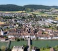 Aerial view of a town with many buildings, a river, and a bridge