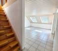empty room, white tiled floor, wooden stairs, two attic windows