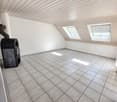 empty room, white tiled floor, white walls, two attic windows, fireplace