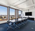 empty conference room with large windows and cityscape view