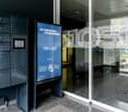 Entrance of office building with security lockers and automated mail delivery system